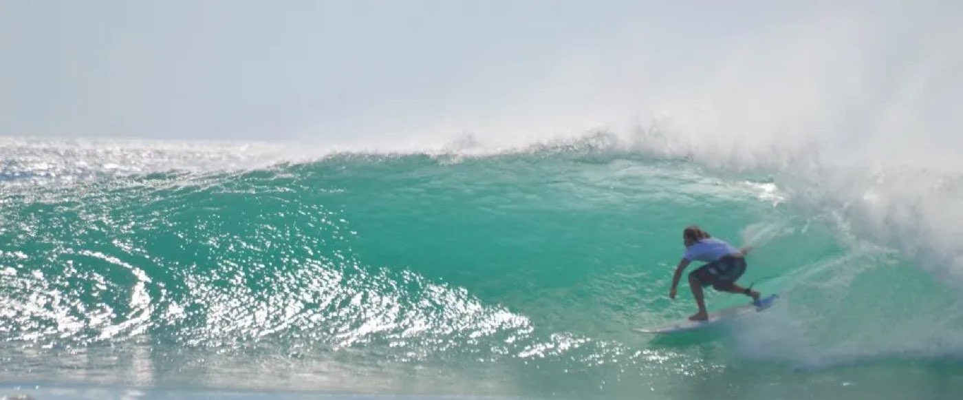 A surfer deep in a clean barrel at Playa Grande, Guanacaste, Costa Rica