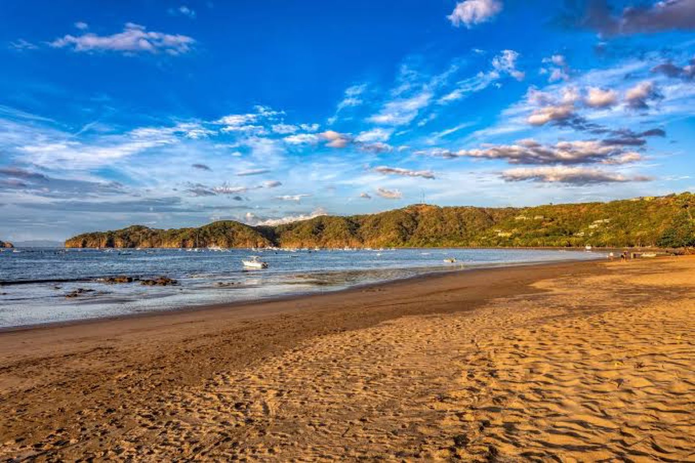 The beach at Playas del Coco, Guanacaste, Costa Rica, in late afternoon light with boats moored in the bay