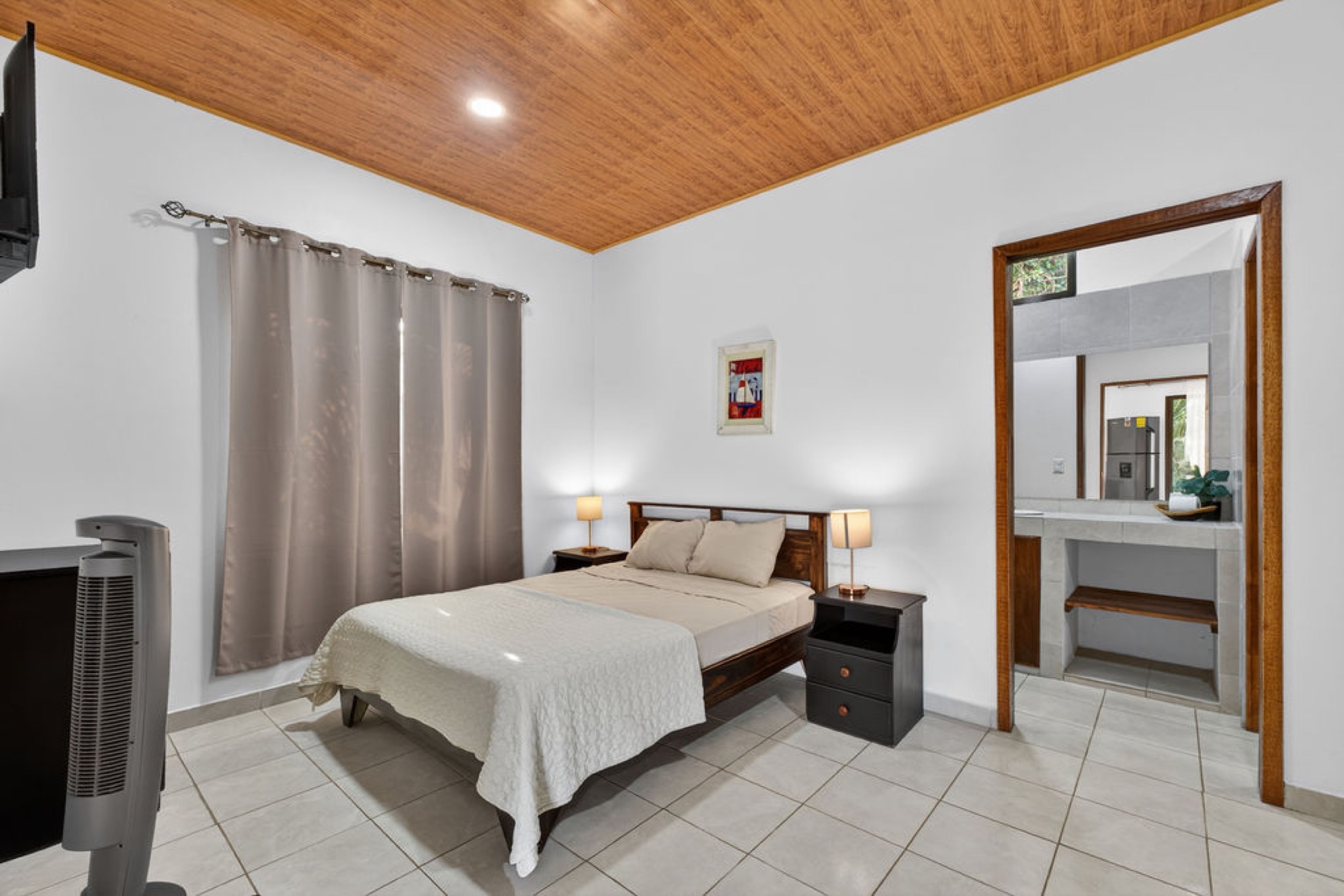 Bedroom with cane ceiling and ensuite