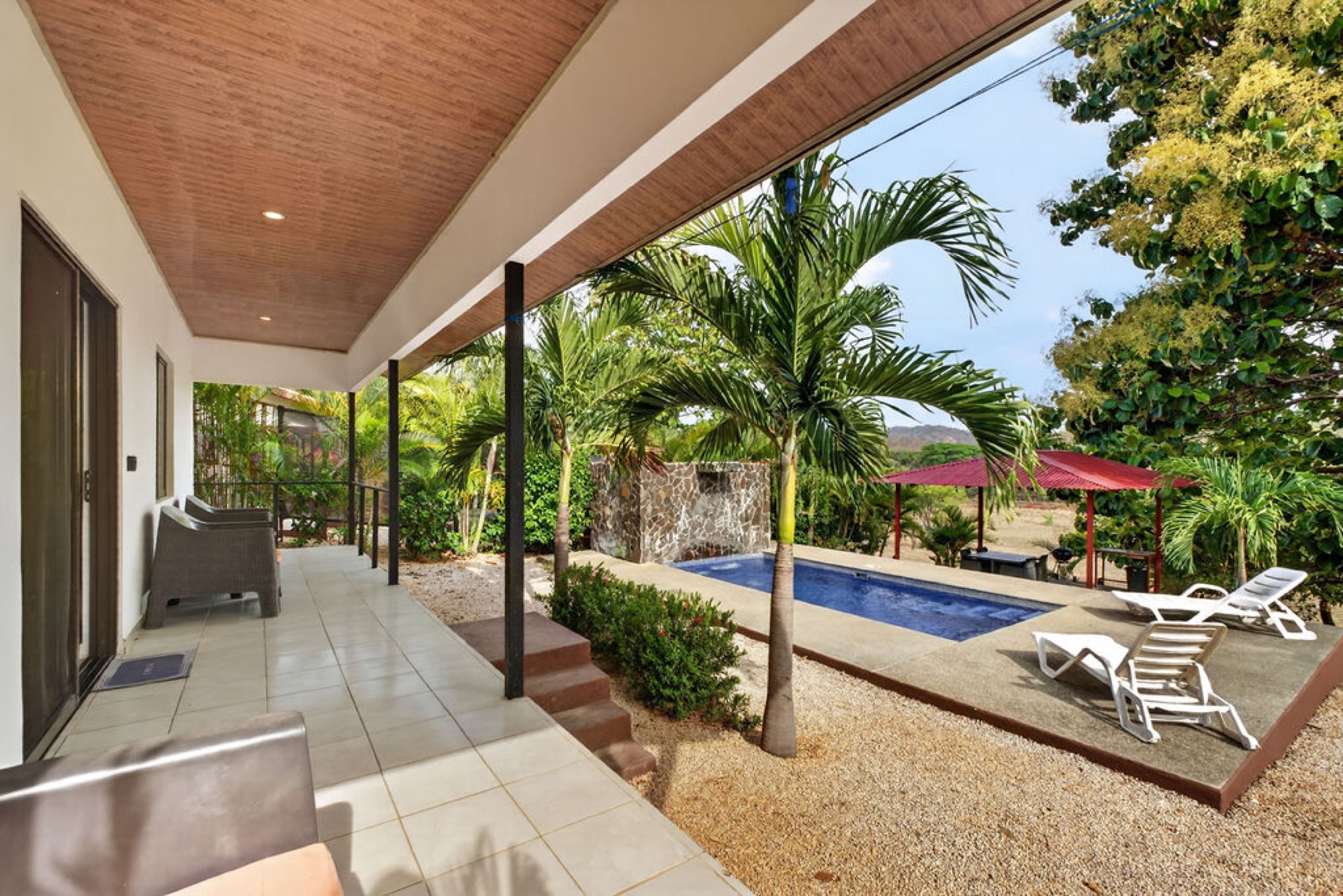 Covered terrace looking out to a private pool