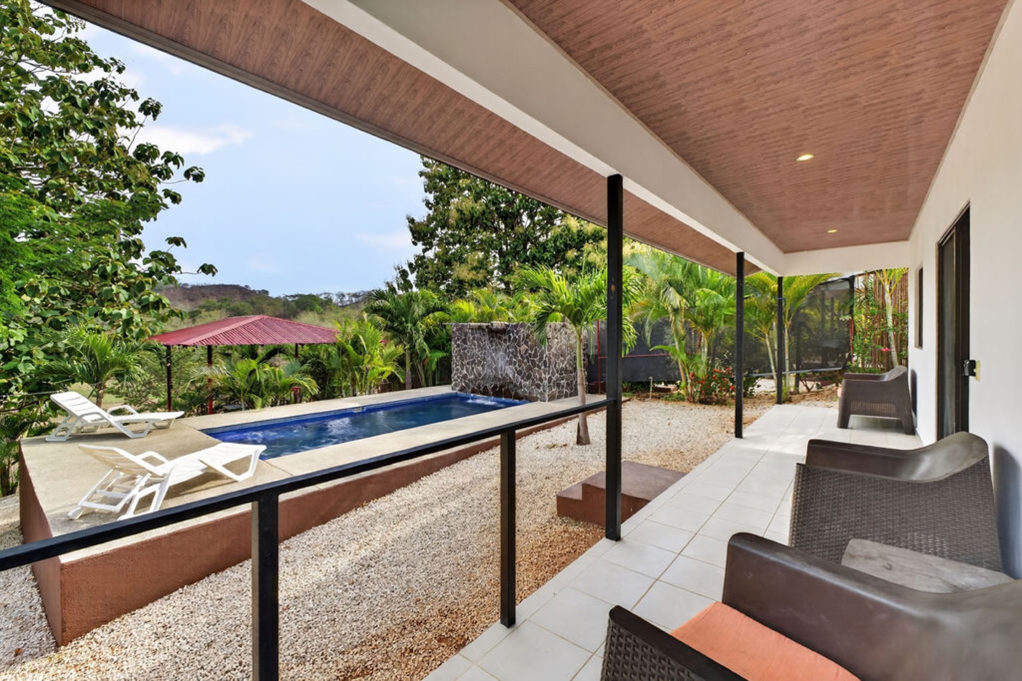 Villa Monos covered terrace beside the communal pool