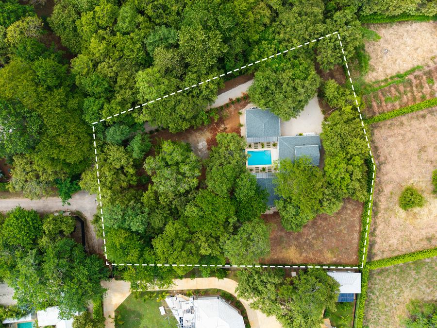 Top-down aerial of the private, tree-canopied grounds with room for a second home