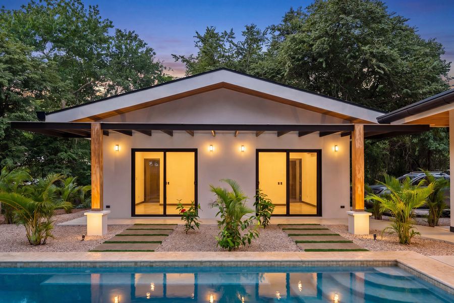 Guest pavilion at dusk across the pool