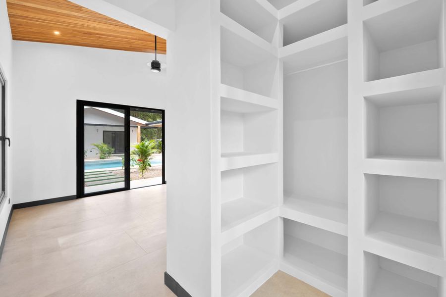 Custom walk-in wardrobe with pool view