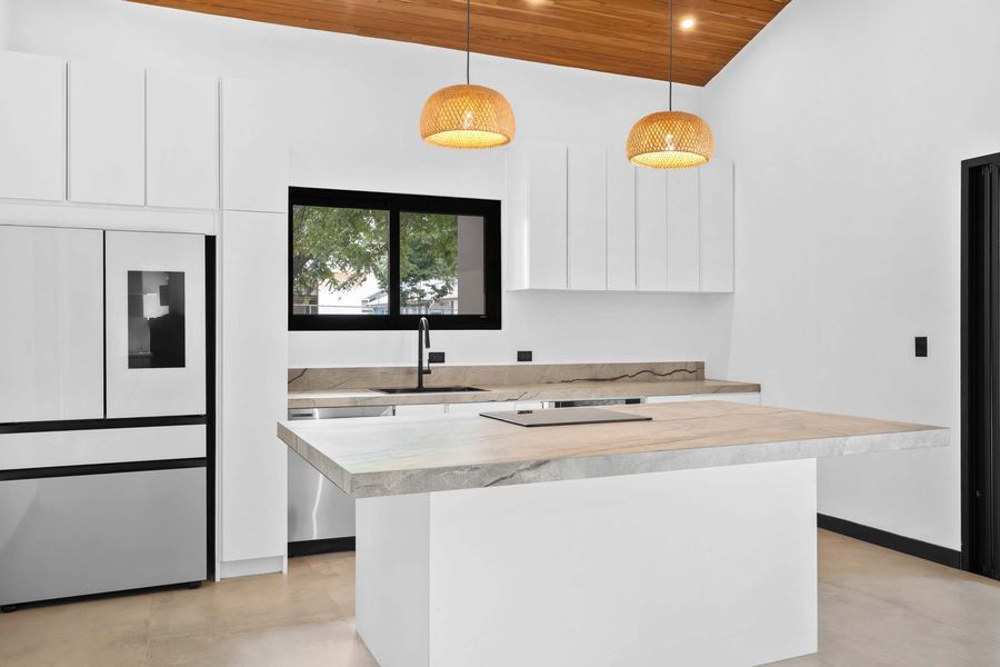 Chef’s kitchen with integrated panel appliances and stone backsplash