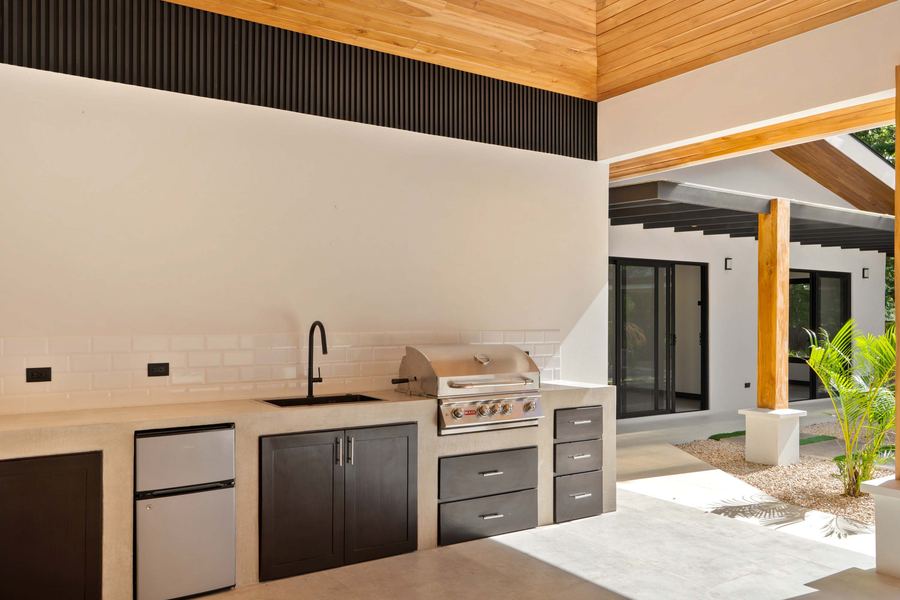 Covered BBQ area with built-in grill and refrigeration